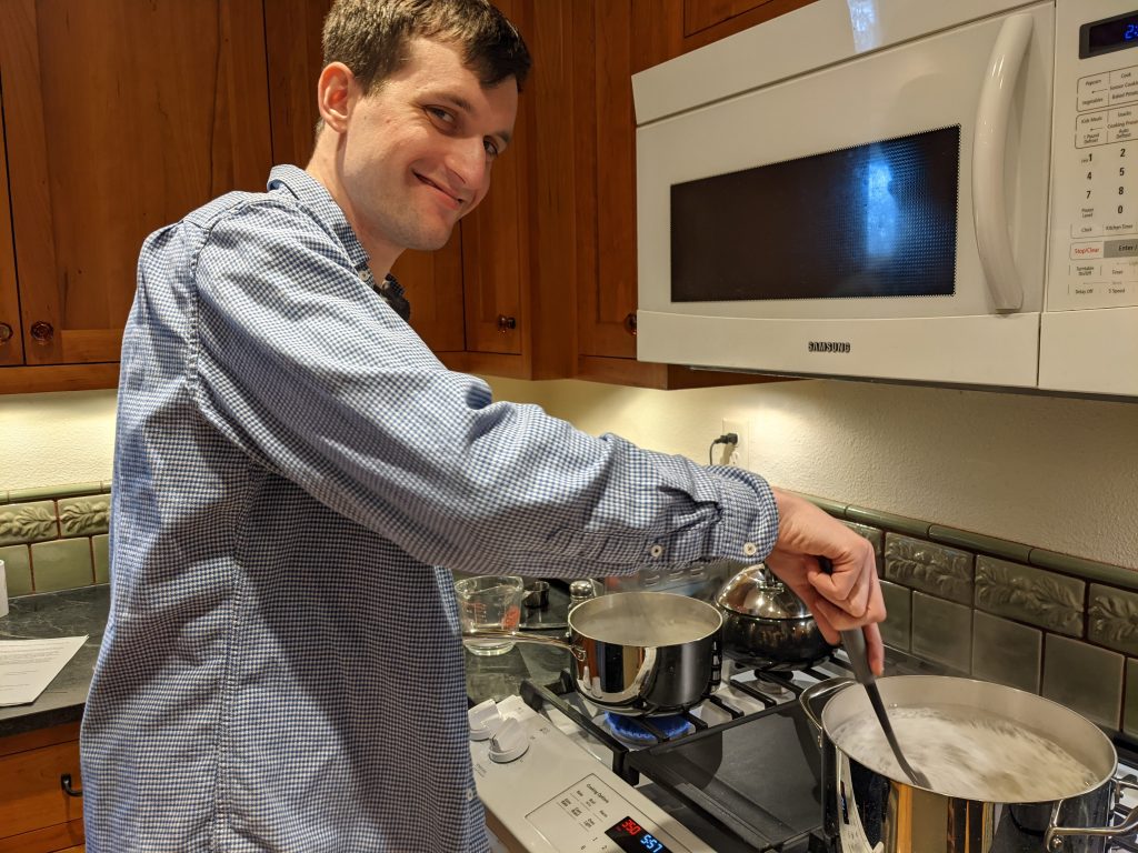 A Dad, stirring two pots at once.