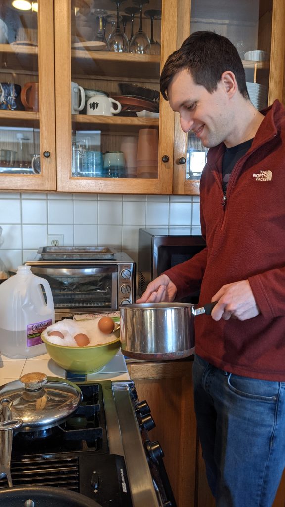 A dad cooking hard-boiled eggs with snow.