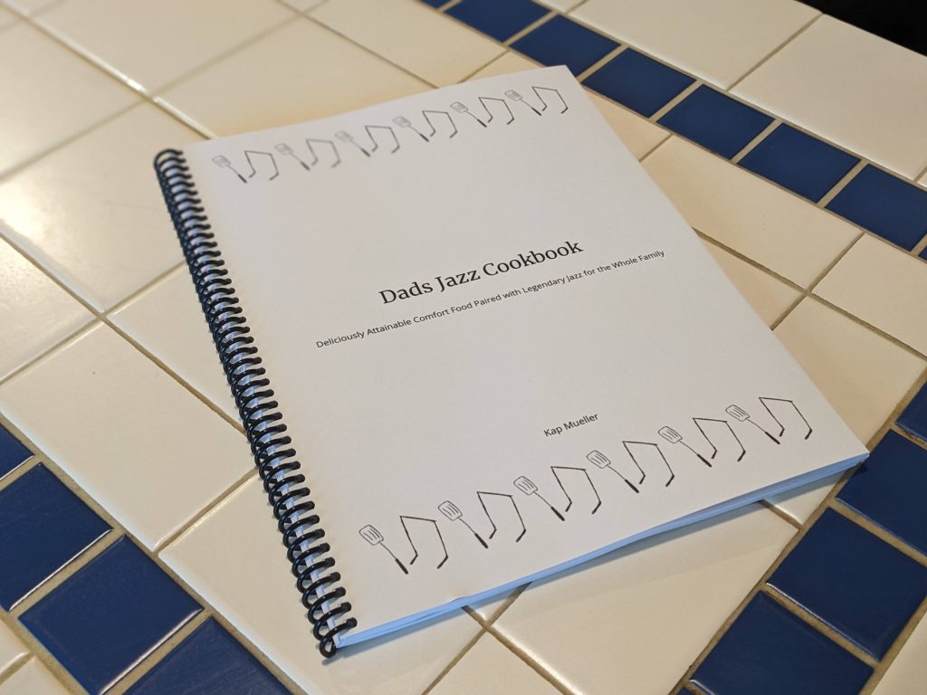 Dads Jazz Cookbook laying on a tiled kitchen counter