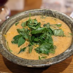 Thai lentil cabbage soup topped with cilantro and basil