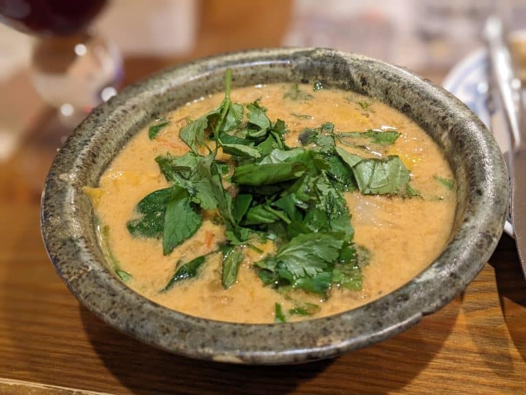 Thai lentil cabbage soup topped with cilantro and basil
