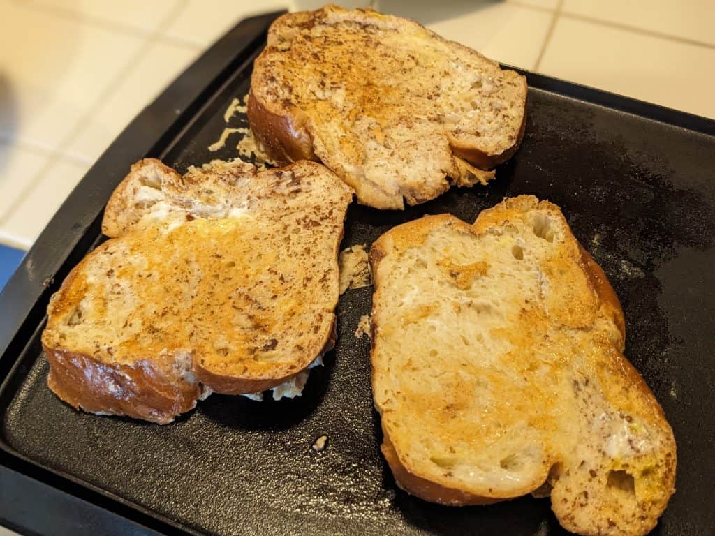 ice cream brioche french toast cooking on the griddle