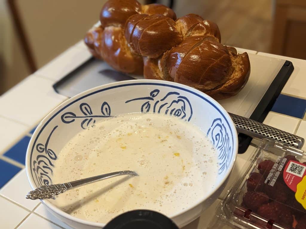 Ice cream brioche french toast batter alongside a loaf of challah